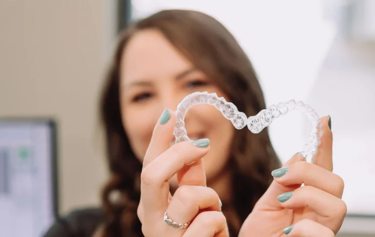 woman displaying Invisalign